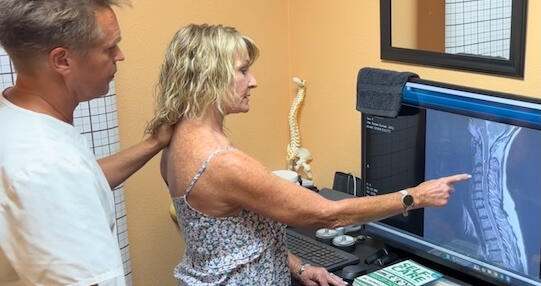Santa Clarita chiropractor reviewing MRI with patient Santa Clarita chiropractor Dr. Thomas Polucki discussing a cervical spine scan with a patient during a consultation