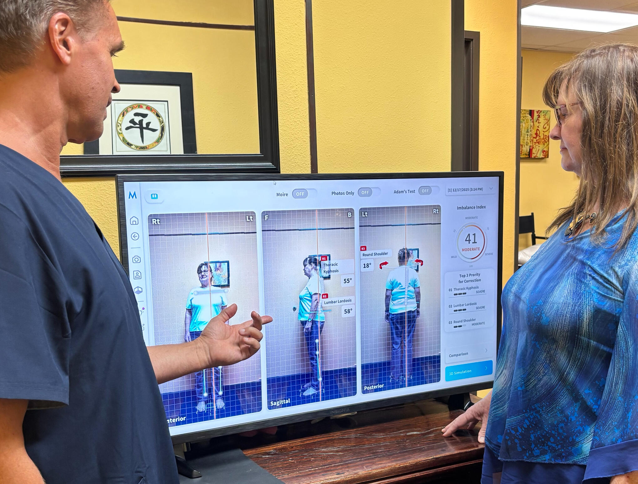 Santa Clarita chiropractor reviewing spine scan with patient Santa Clarita chiropractor Dr. Thomas Polucki observing posture with a patient during a consultation