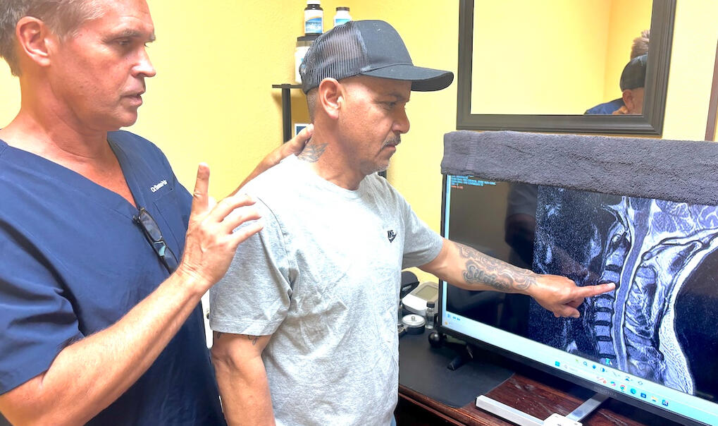 Santa Clarita Chiropractor Consultation Dr. Thomas Polucki reviews imaging with new injury patient