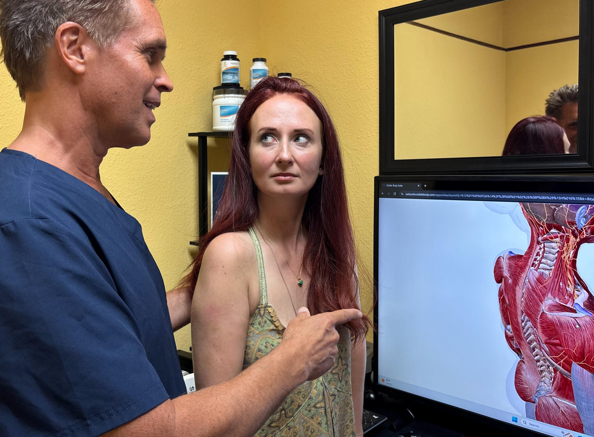 Santa Clarita chiropractor reviewing migraine anatomy with patient Santa Clarita chiropractor Dr. Thomas Polucki discussing cervical spine with a patient during a consultation