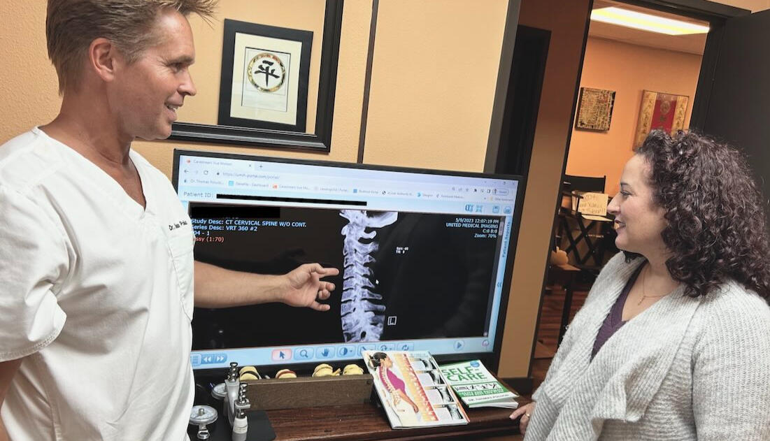 Progress review in Santa Clarita Dr. Thomas Polucki reviewing posture and recovery progress with a patient during a chiropractic visit in Santa Clarita.